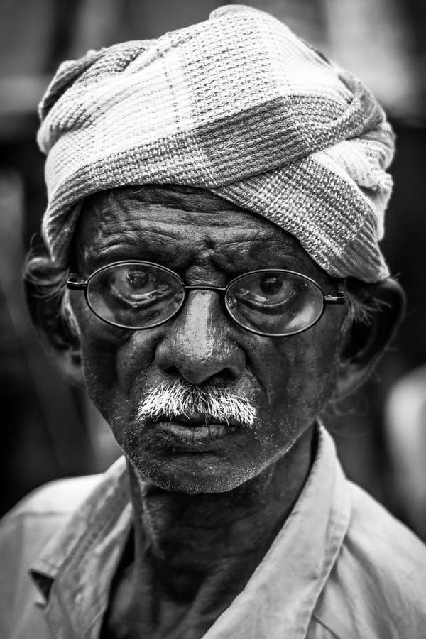 Anger and Tears. A hawker in Kondapur — the very likeness of Mahatma Gandhi — turning angry and teary-eyed the moment he noticed the camera. Black and white.